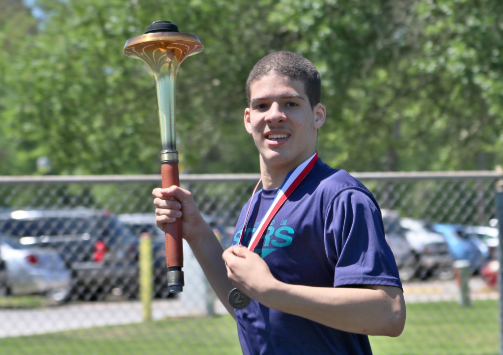 Ian Ashley, an athlete from Oak Ridge High School, carries the torch during a leg of the Opening Ceremonies at The Woodlands Kiwanis Club’s 32nd Annual Special Olympics Invitational held April 2, 2016.