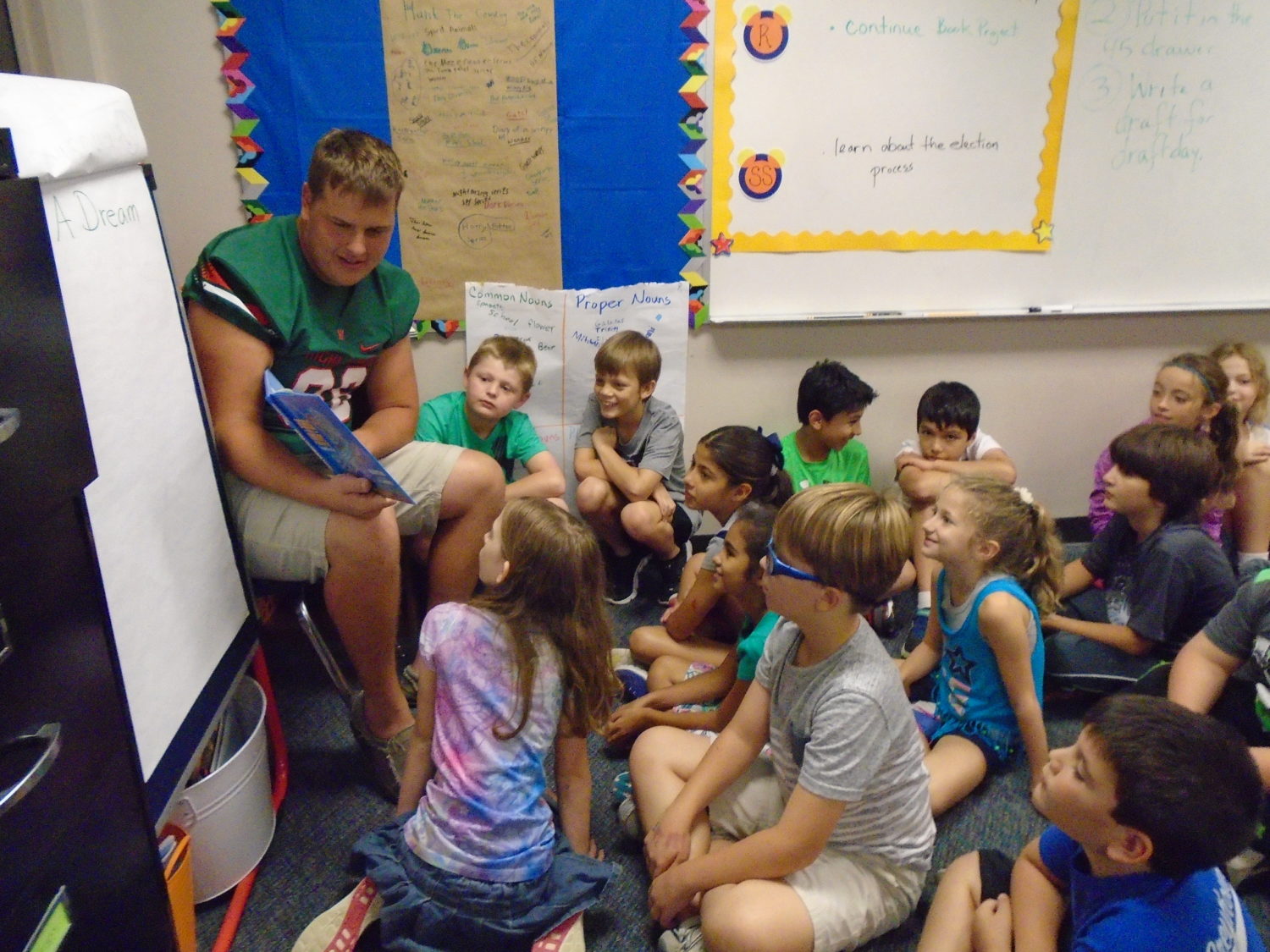 A football player from The Woodlands HS read to Ms. Johnson's fourth grade class at Galatas Elementary.