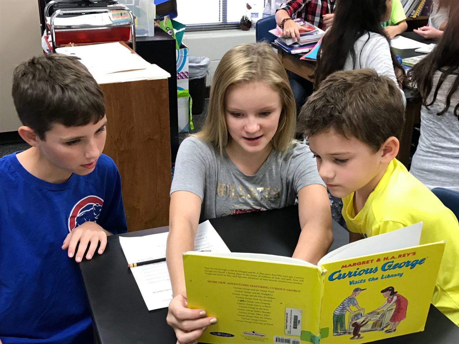 Sixth grade students read with their kindergarten buddies at Tough Elementary.