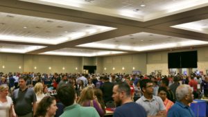 A large group of people in a convention hall.