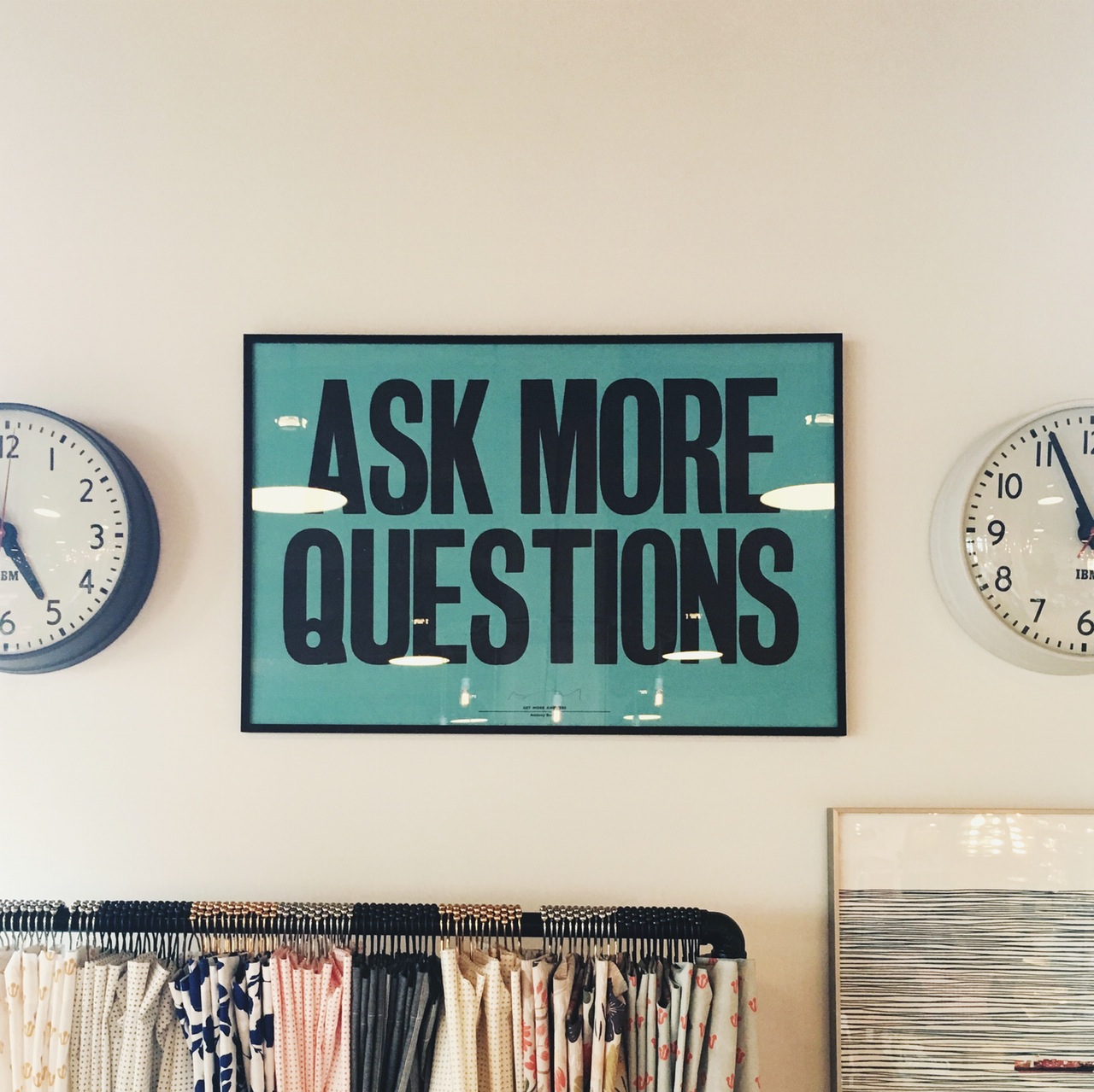 Poster on the wall that states "ask more questions"