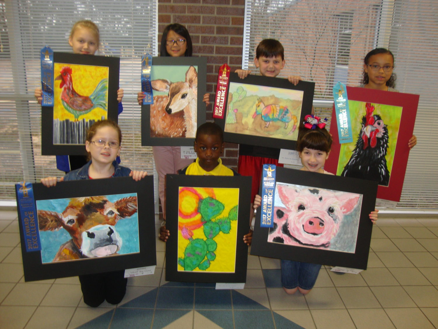 Western Art Show winners from Giesinger proudly display their paintings.