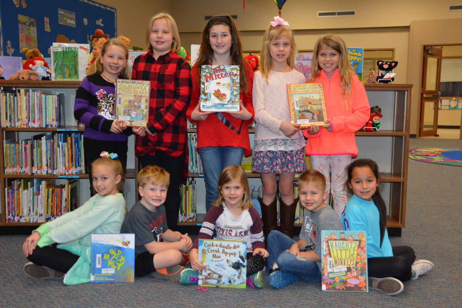 Students from Ride Elementary pose with books donated to the library in honor of our Conroe ISD School Board.