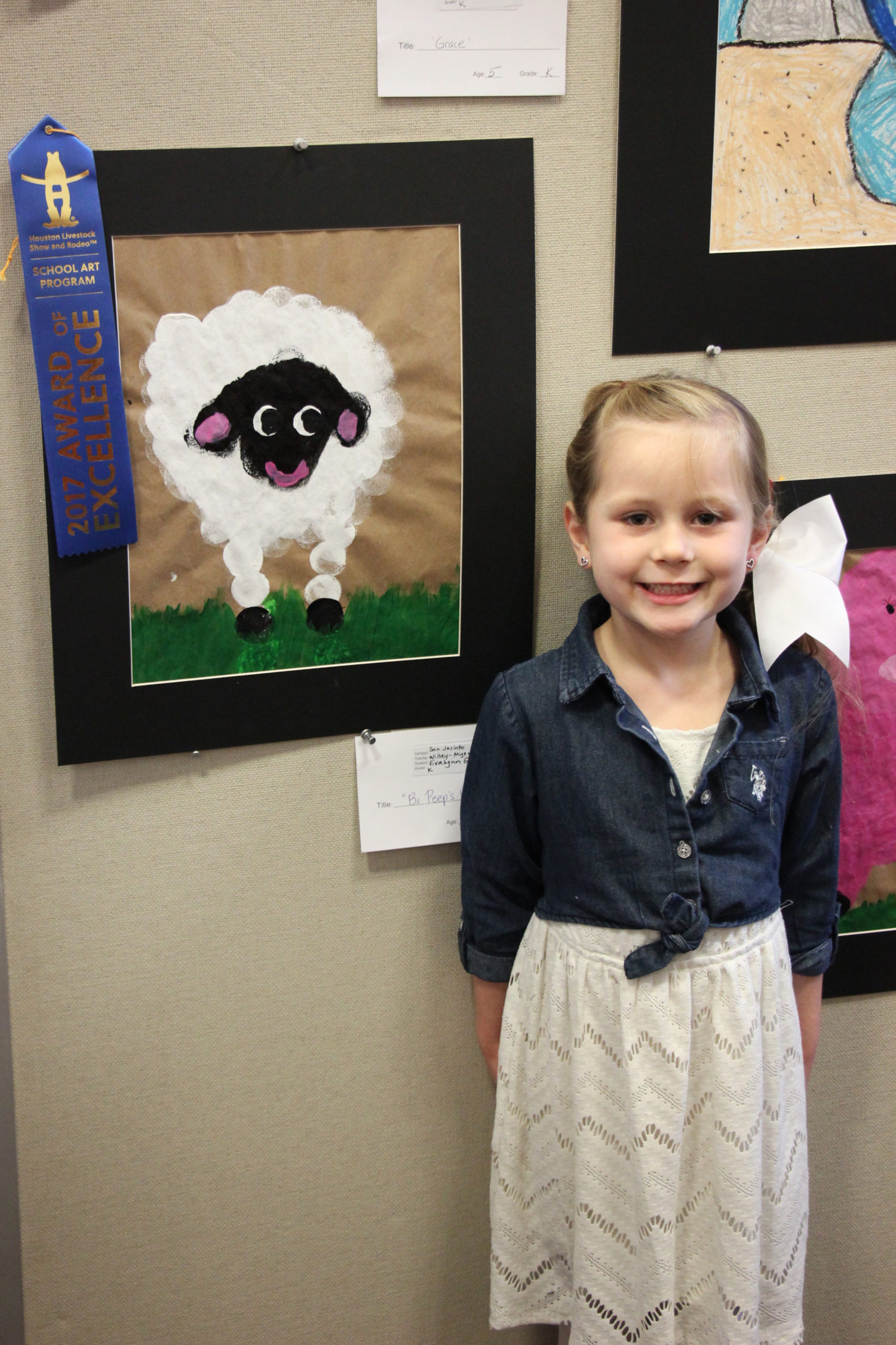 A student from San Jacinto proudly stands by her art at the Western Art Show.