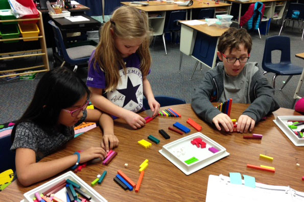 Third grade students at Powell Elementary learn about fractions in small math groups.