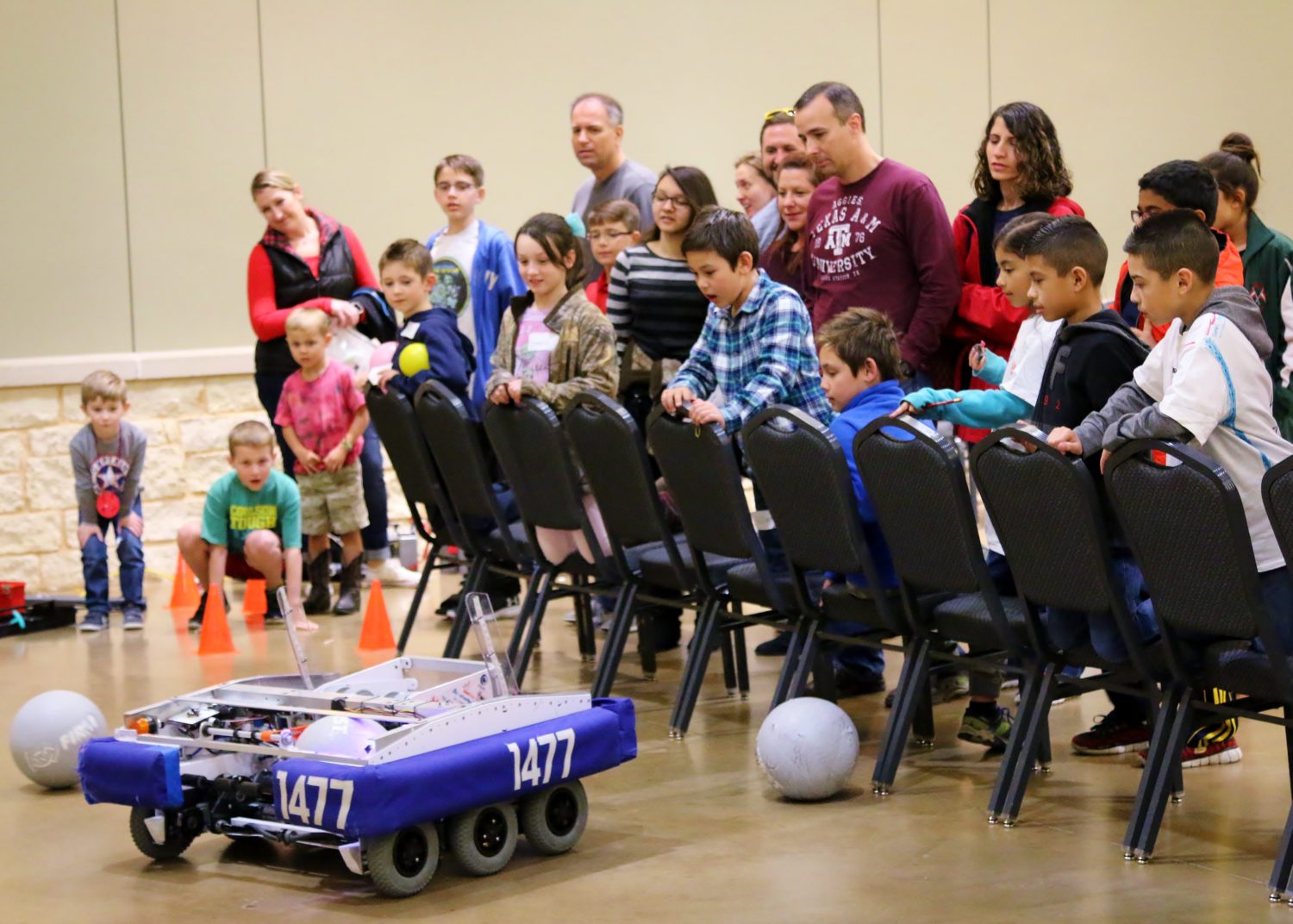 Onlookers anxiously await for a ball to be launched during a Robotics Demonstration during the Sci://Tech Exposition on Saturday.