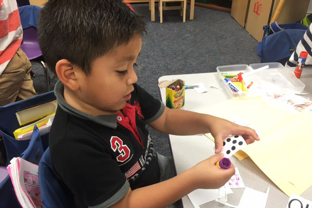 A Ford kindergarten student works hard in class.