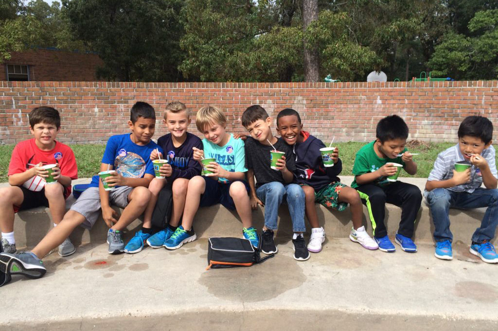 Second graders at Giesinger enjoy a frozen treat outside with friends.