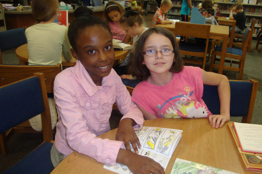Fourth graders at Giesinger find fun books to share in the library.