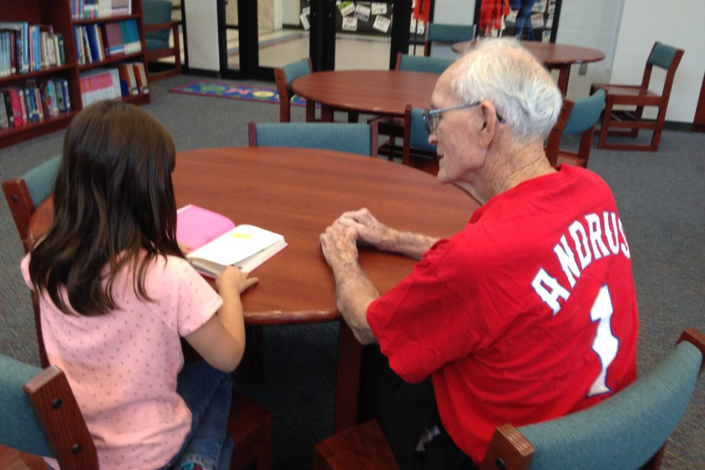 A Houston Elementary volunteer listens intently to a student read.