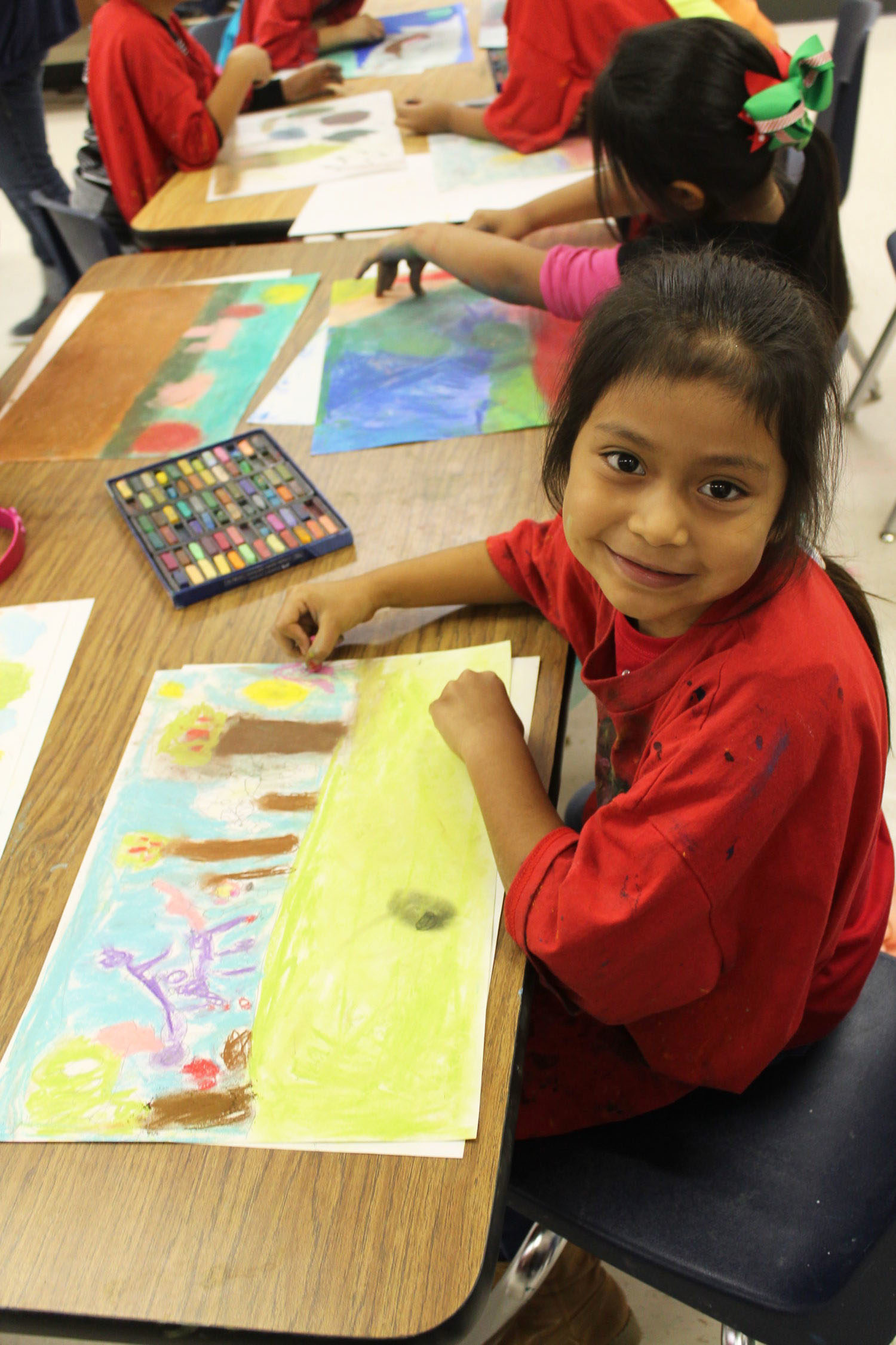 A Rice student smiles for a picture with her artwork.