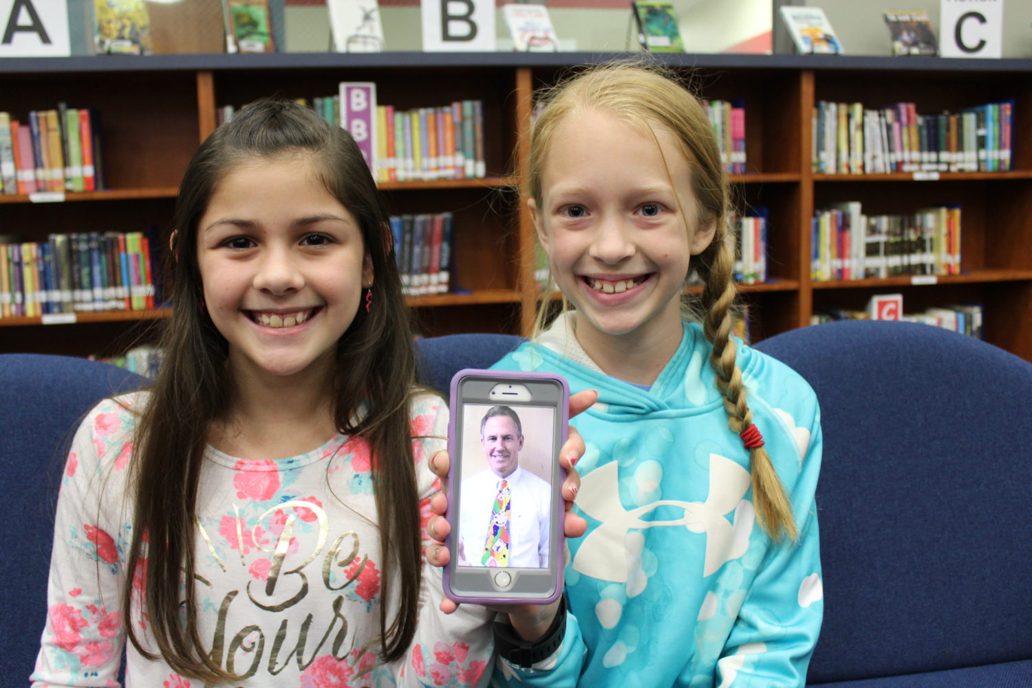 Wilkerson Intermediate artists from Ms. Graham's art class pose with a picture of Dr. Stockton wearing the tie they designed and created for Big Art Day in CISD.