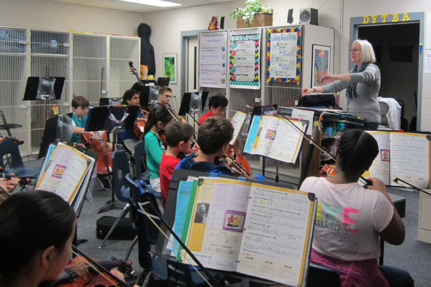 Collins' orchestra practices hard for their upcoming concert.