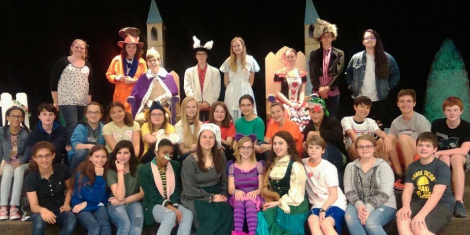 The Knox Drama Department smiles for a picture while practicing for Alice in Wonderland.