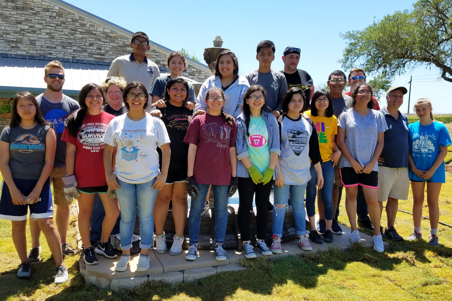 The Caney Creek HS Leo Club smiles for a picture while at a work weekend at Texas Lion's Camp in Kerrville.