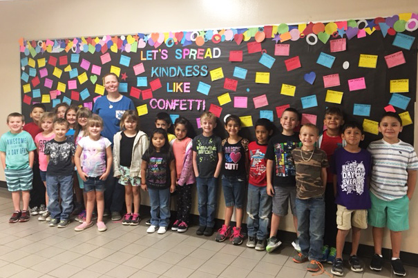 Mrs. Vitale's first grade class at Creighton Elementary shows off their Kindness Board.