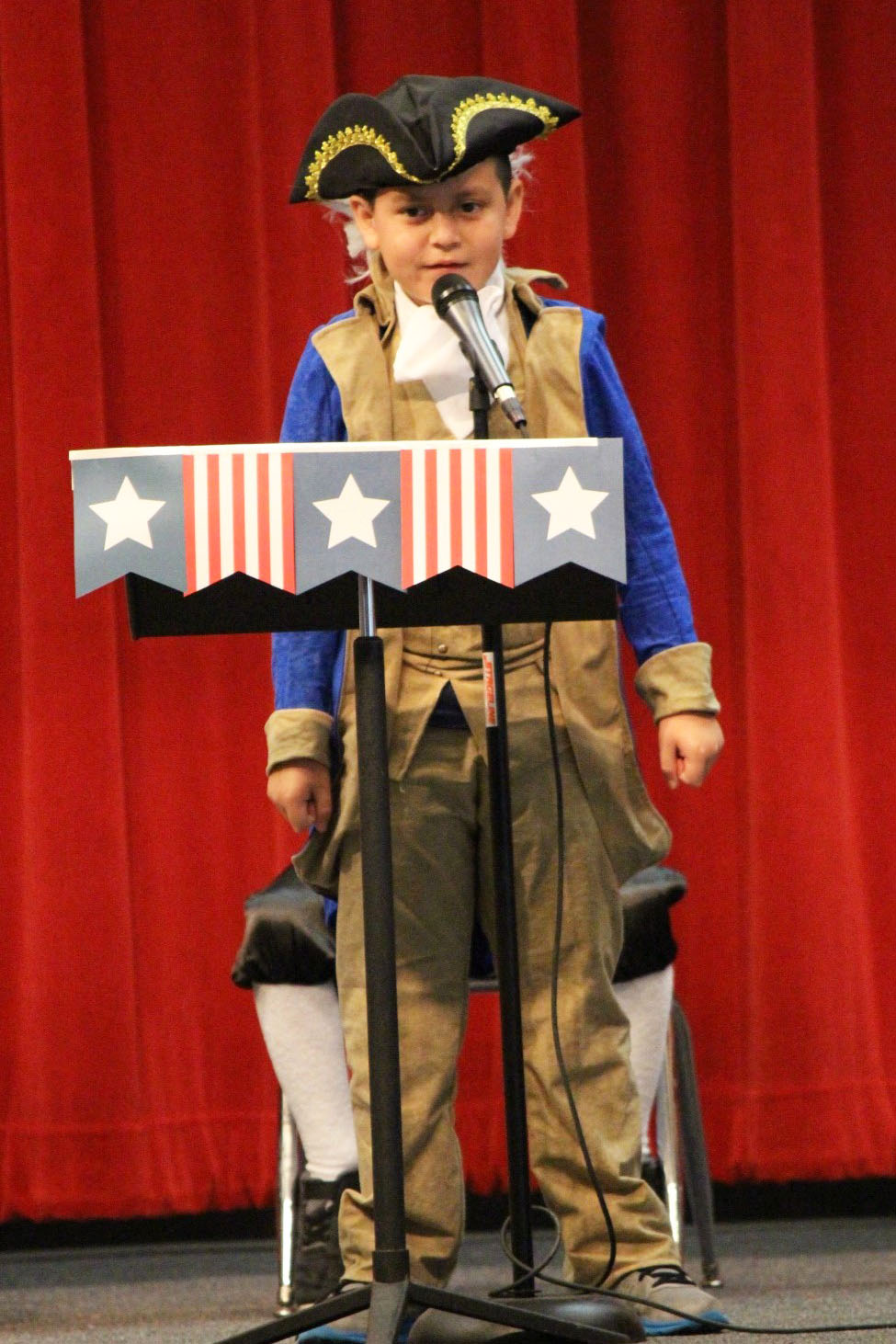 A second grader performs in a music program at Lamar Elementary.