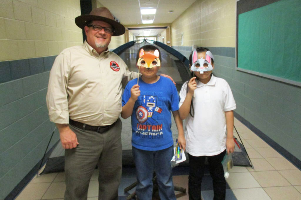 A Reading Ranger and two Milam Elementary "campers" smile for picture.
