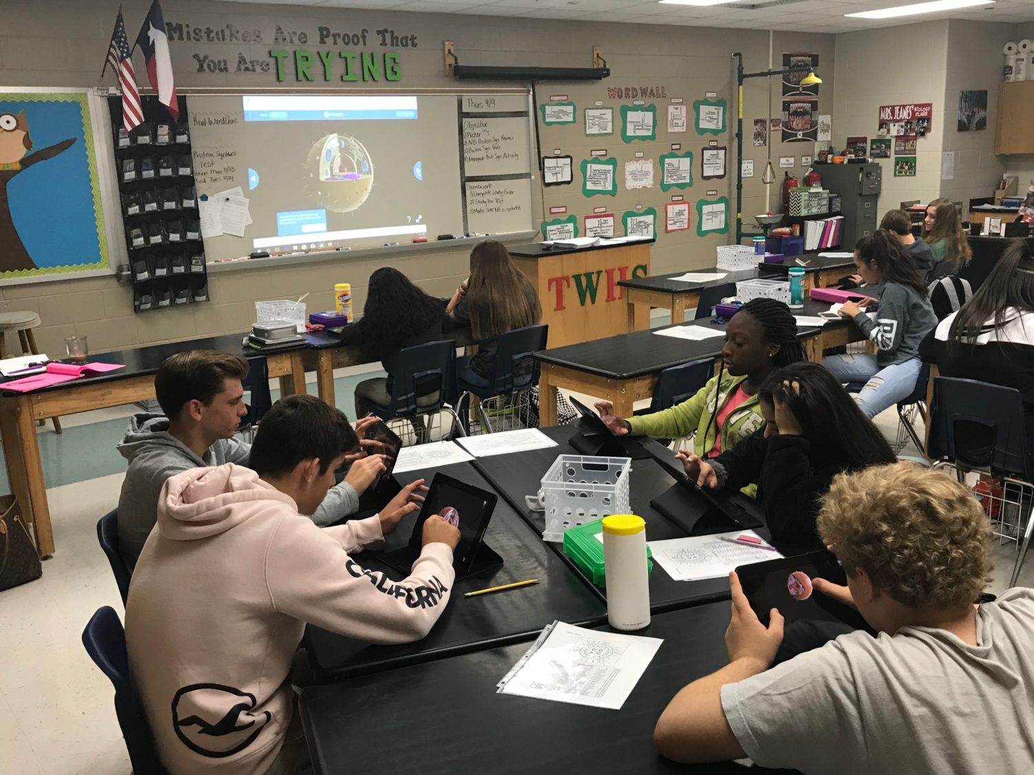 group of students learn about biology using technology