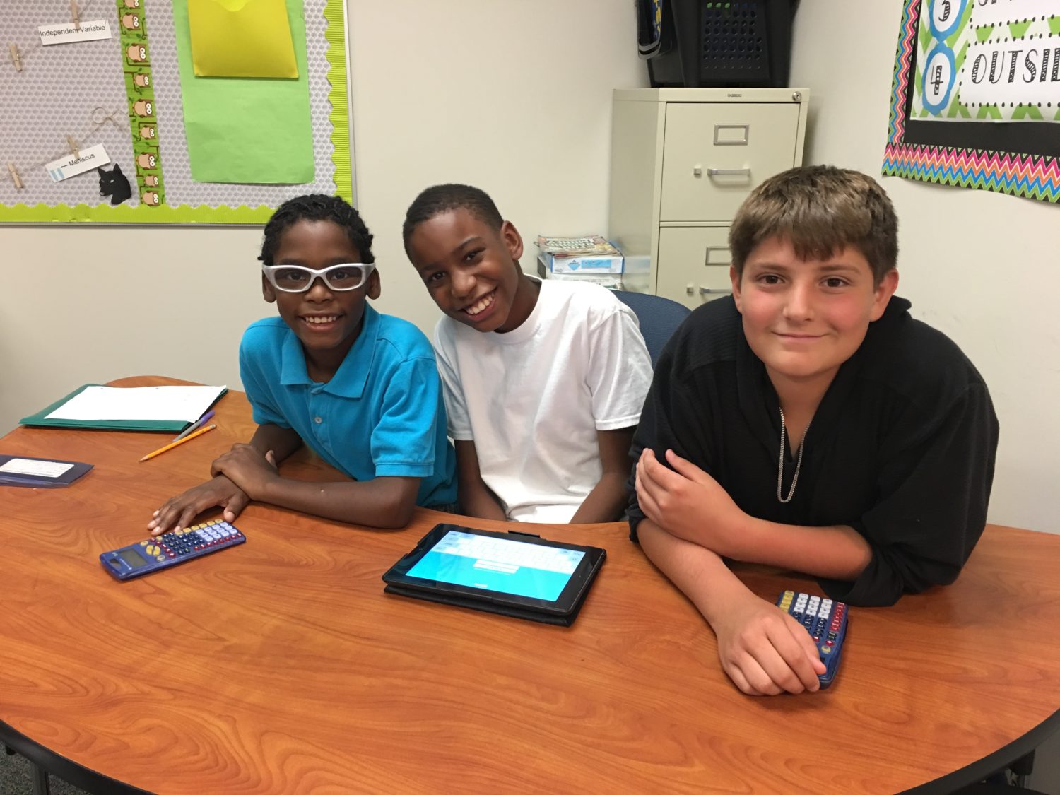 three boys use technology to help with learning