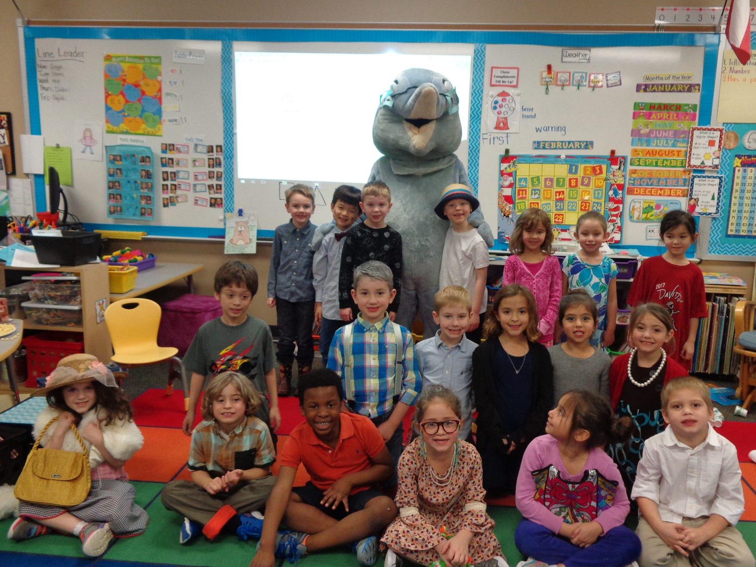 a class poses for a picture to celebrate 100 days of school