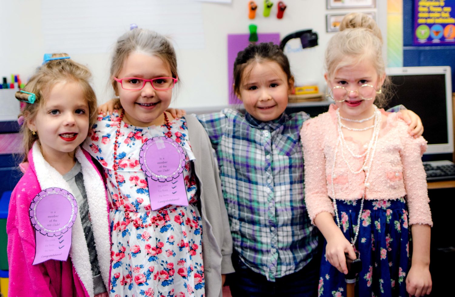 four students dress like they are 100 years old to celebrate 100 days of school