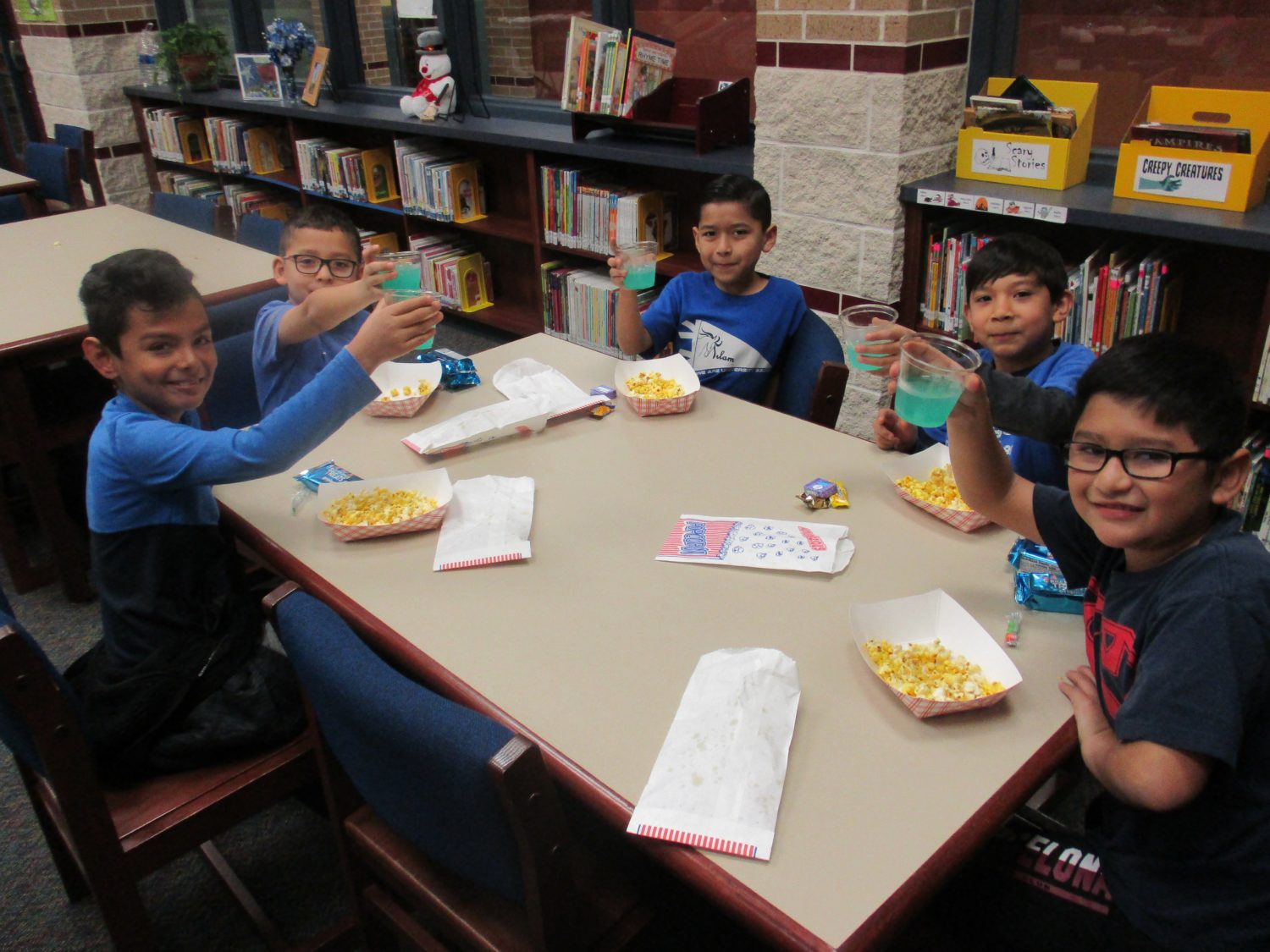 a group of boys celebrate books with a popcorn party