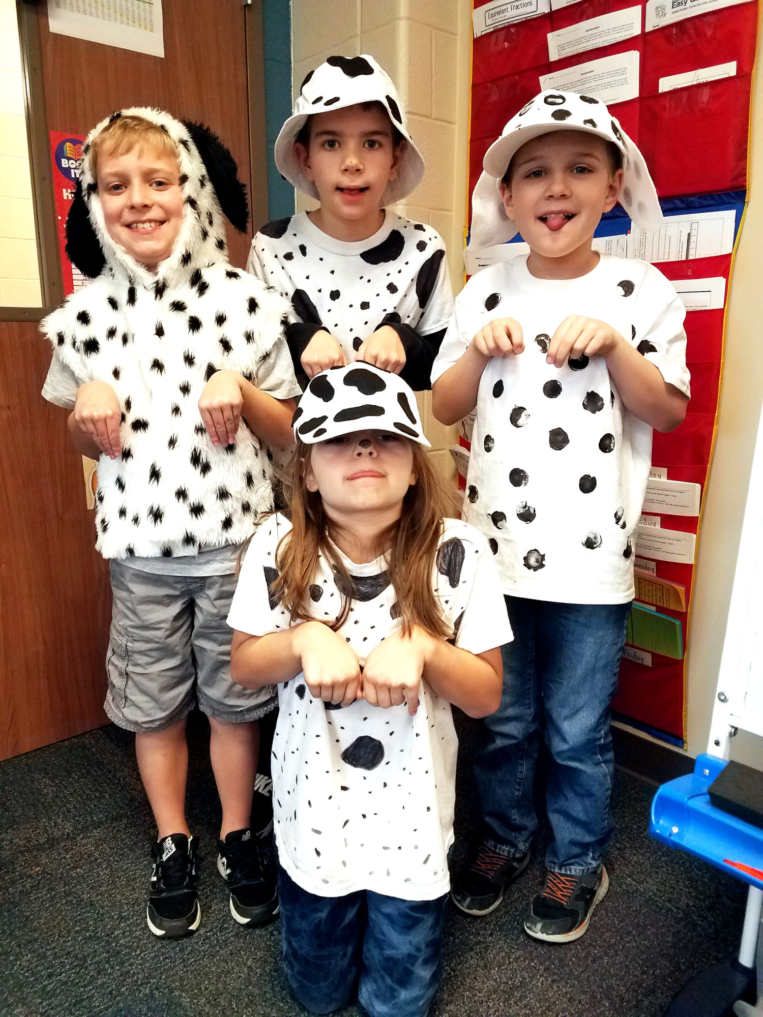 four students dress like 101 dalmatians to celebrate 101 days of school