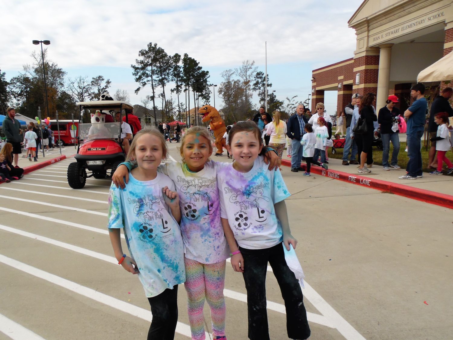 three girls pose for a picture after a color run