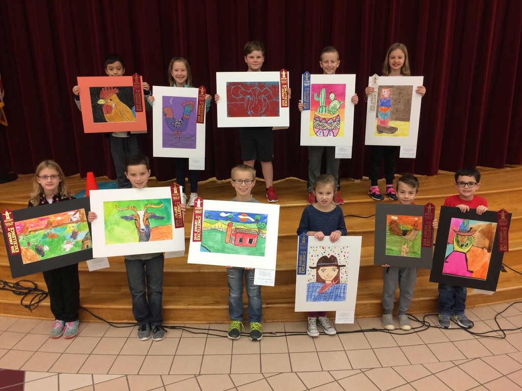 a group of students proudly display their winning rodeo art