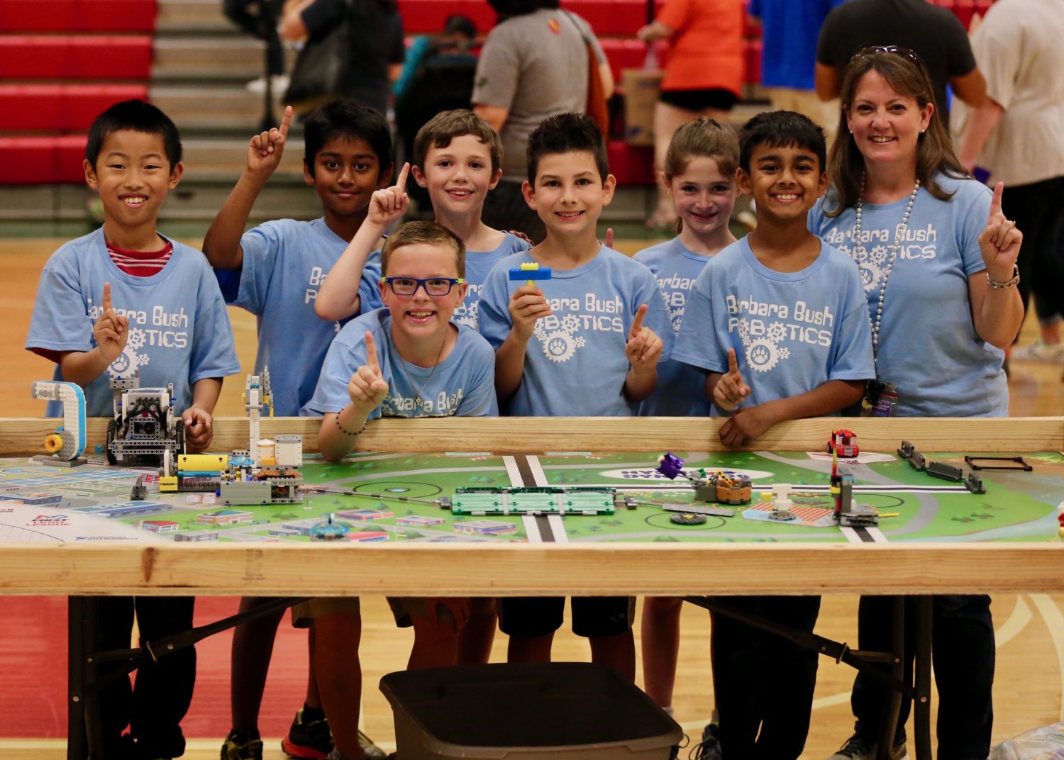 "the robotics team poses for a picture after their competition"