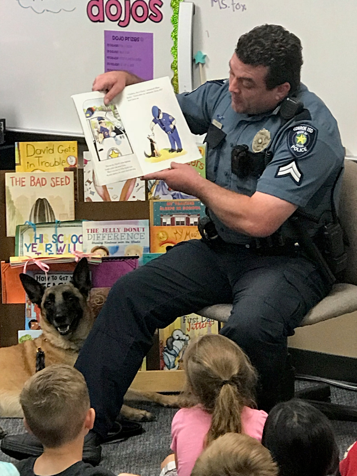 "an officer and his K-9 read to a class"