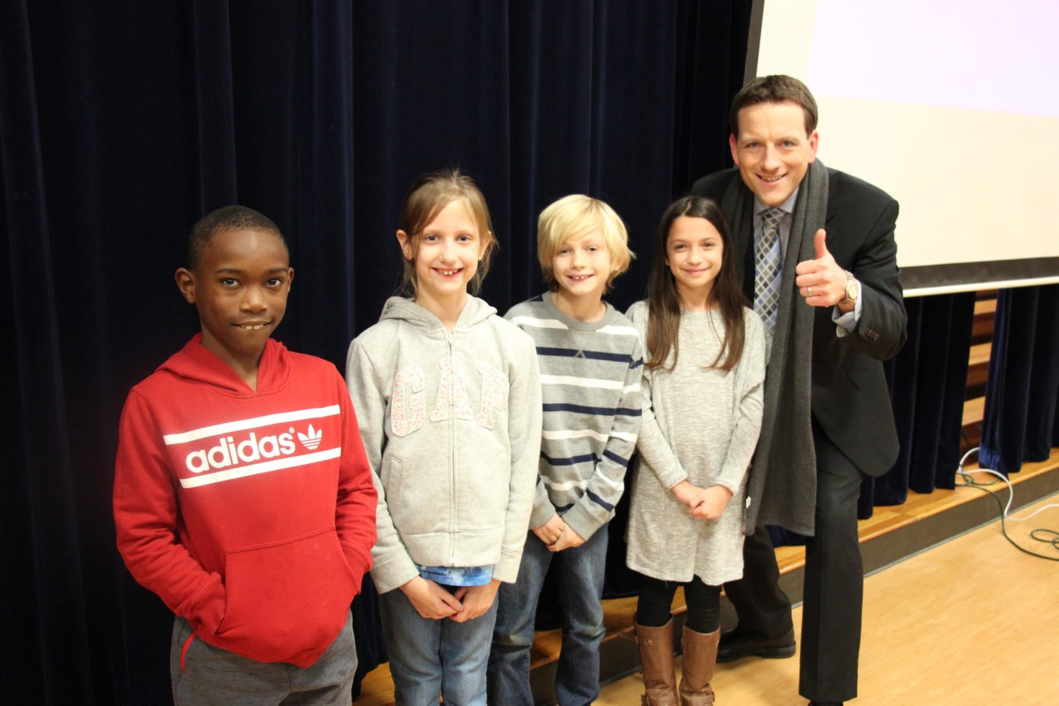 "a group of children pose with a weather personality"
