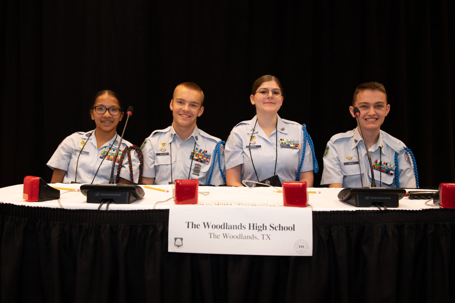 "four members of the JROTC sit at a table"