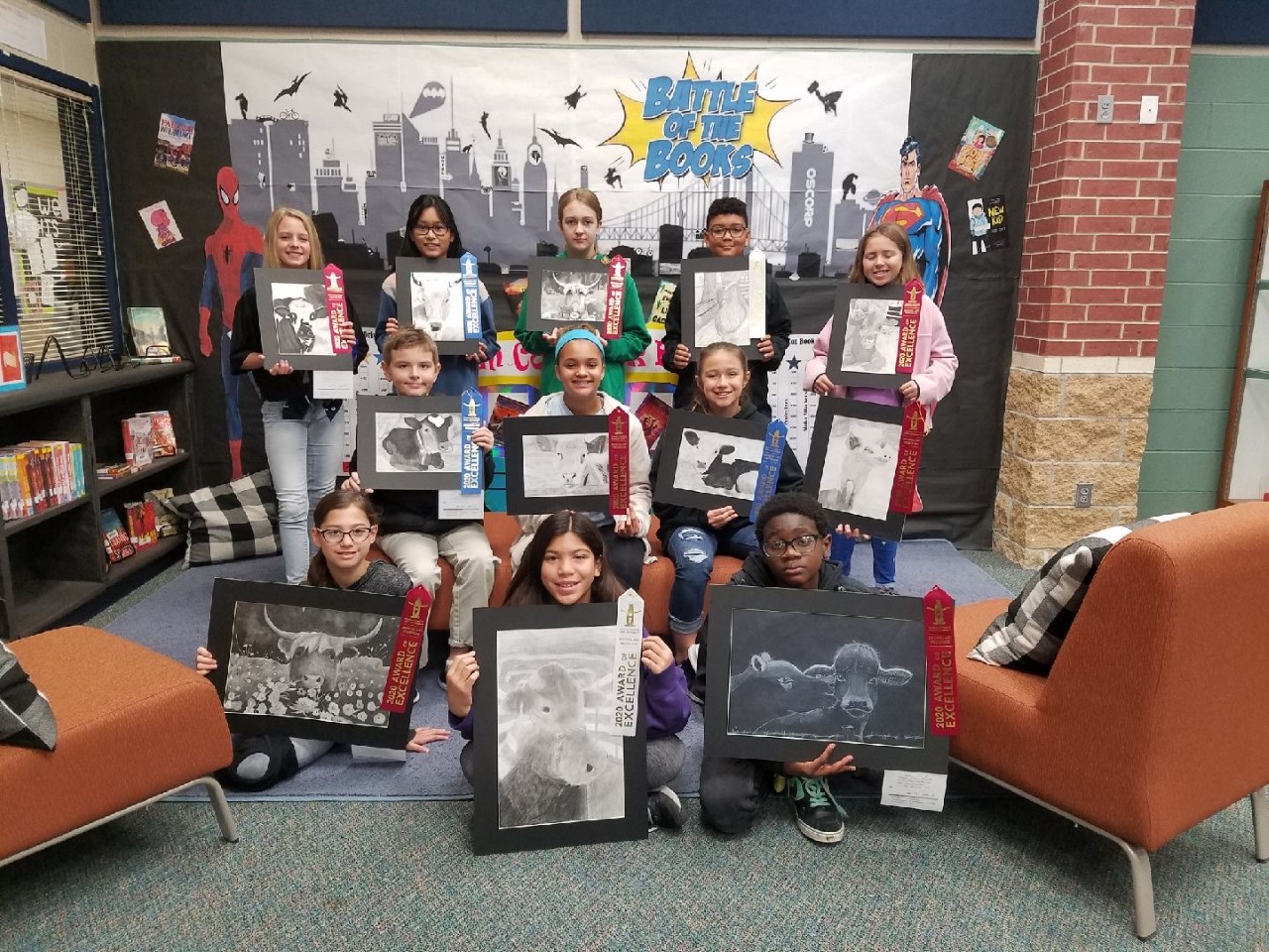 "Students hold up the artwork they created"