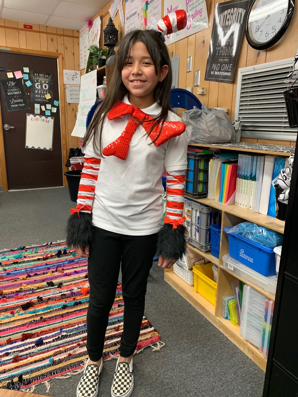 "a student dressed in Dr. Seuss attire smiles"