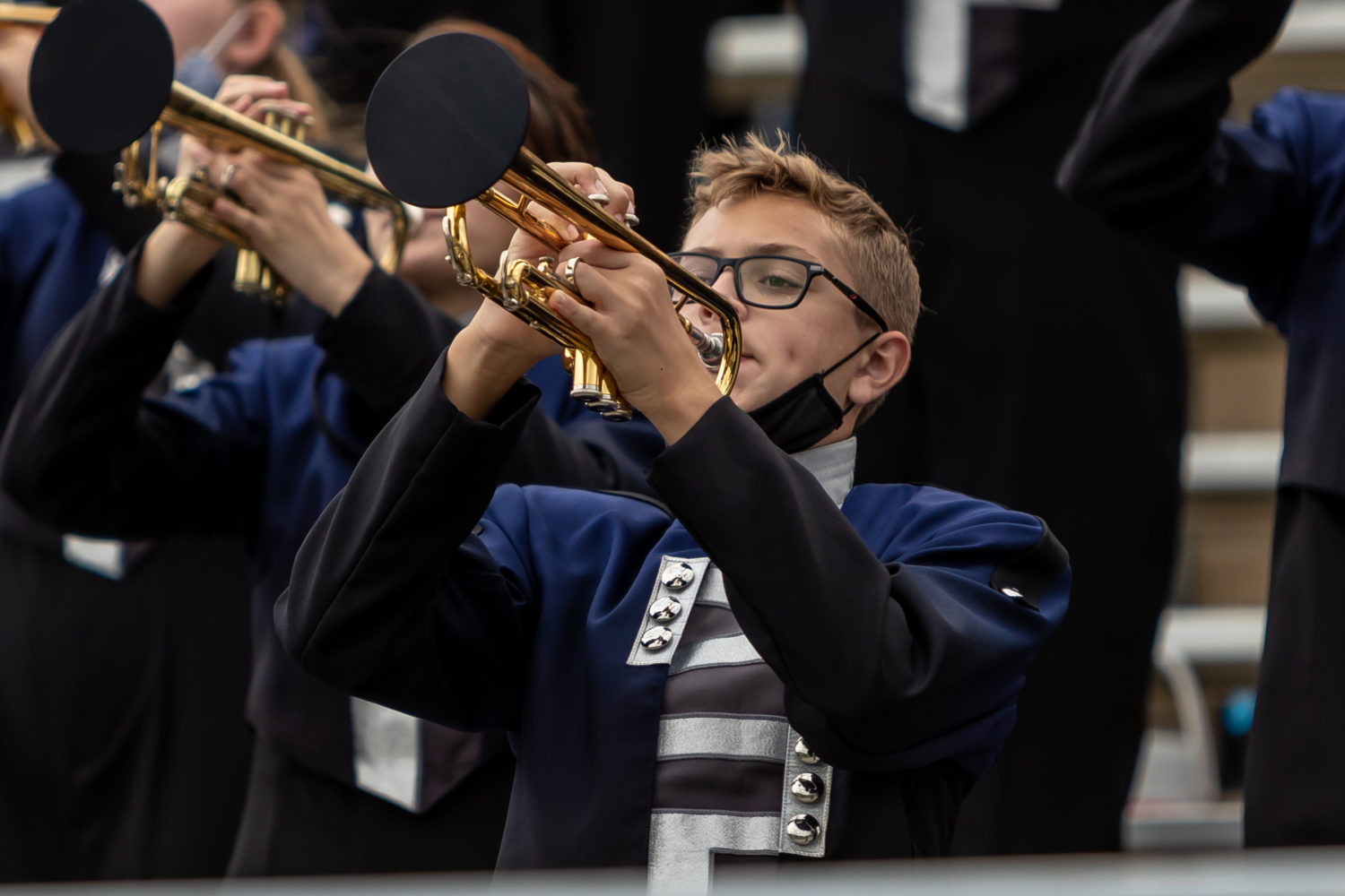 " Student holds trumpet while playing"