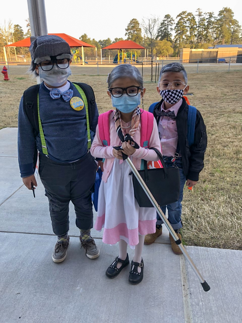 Students smile for the camera while dressed up for the 100th day of school