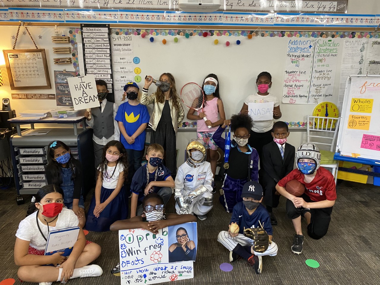 A group of students smile for the camera while dressed up in costumes.