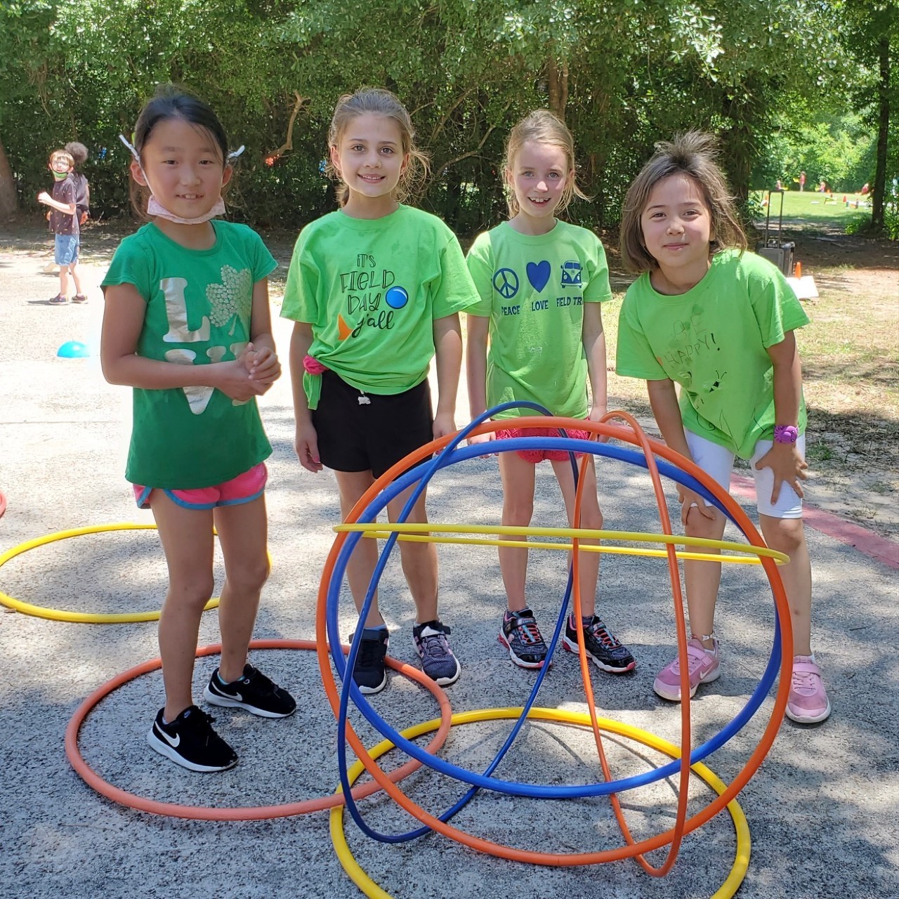 Students complete an activity with hula hoops during field day.