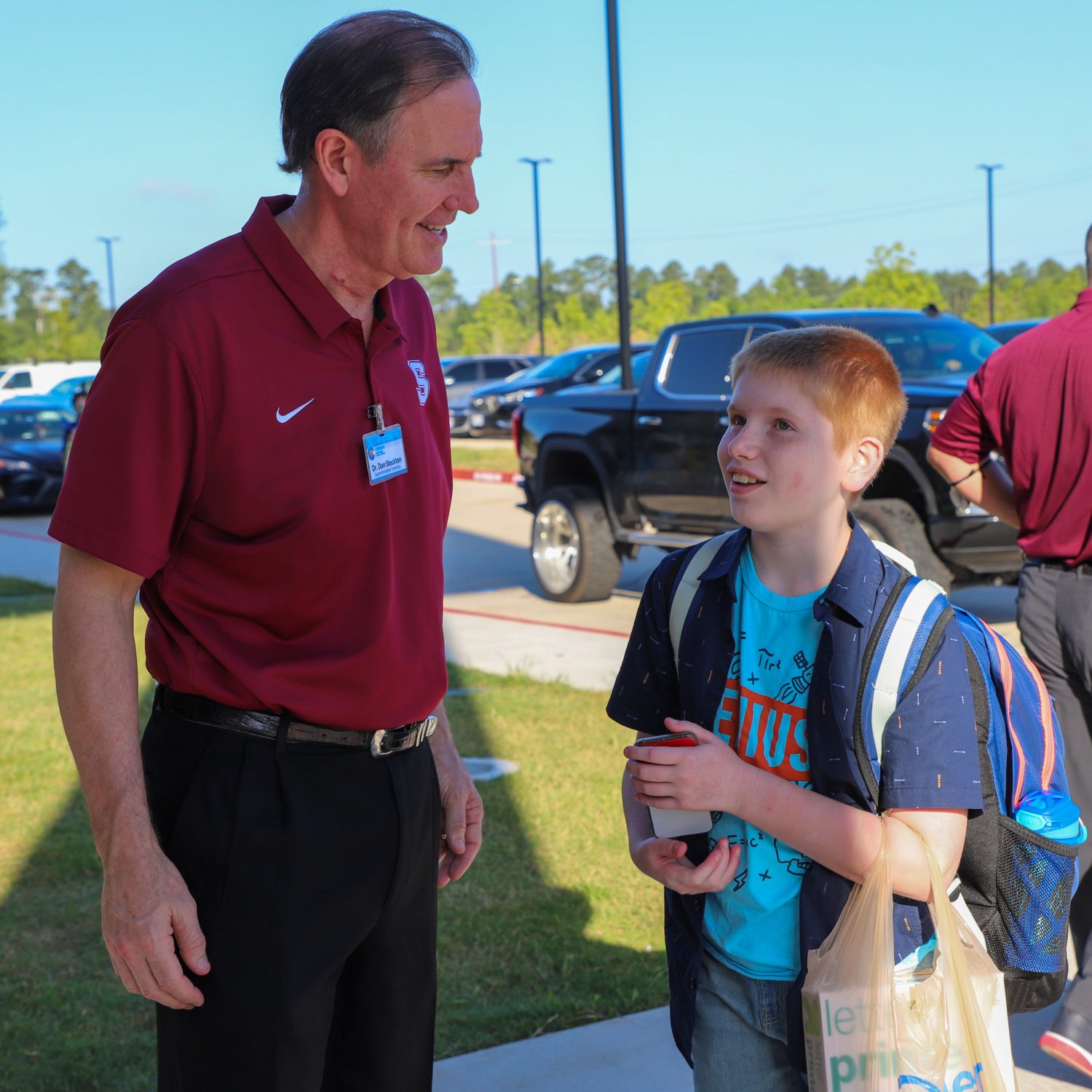 "A Student is greeted as they enter the school building."