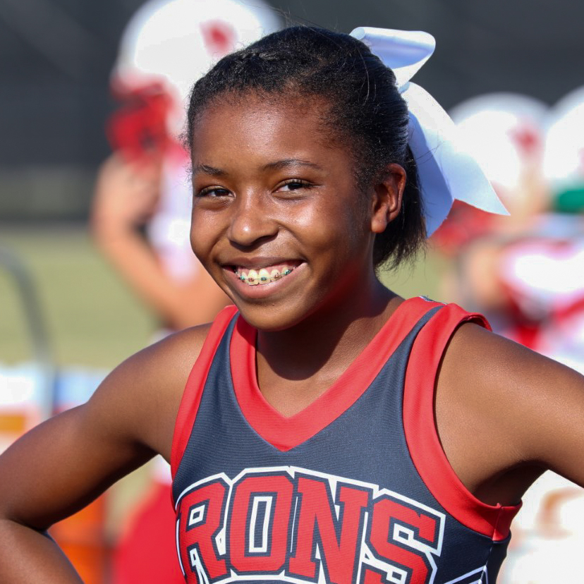 A cheerleader smiles for the camera.