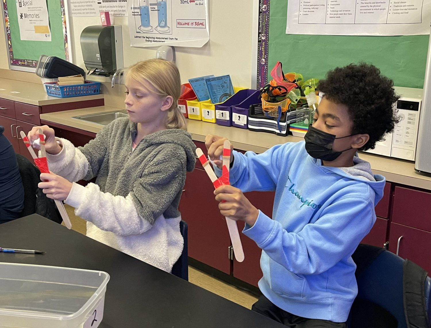 Two students work together on a lab.