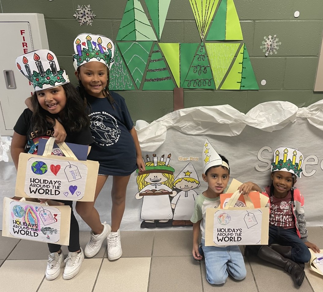 Students smile for the camera while participating in a holiday activity.