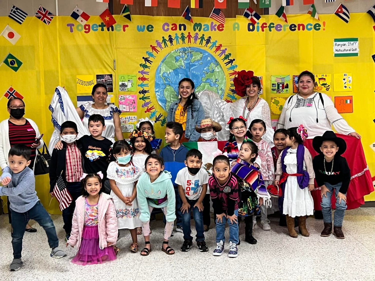 A group of students and staff smile for the camera.