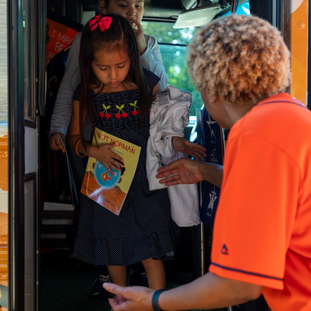 Representatives from the Astros Foundation and Oxy visited Armstrong to deliver Buddies Club backpacks and let students select books from the Astros Literacy Bus.