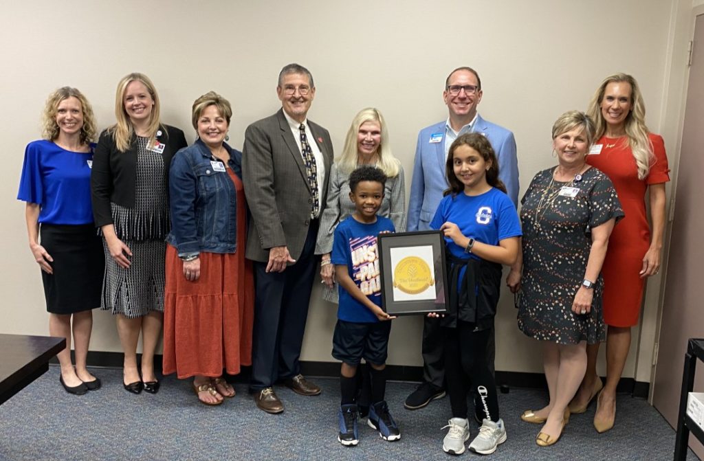 Conroe ISD district and student representatives pose for a picture after receiving the 2023 Hometown Hero honor by Interfaith of The Woodlands.