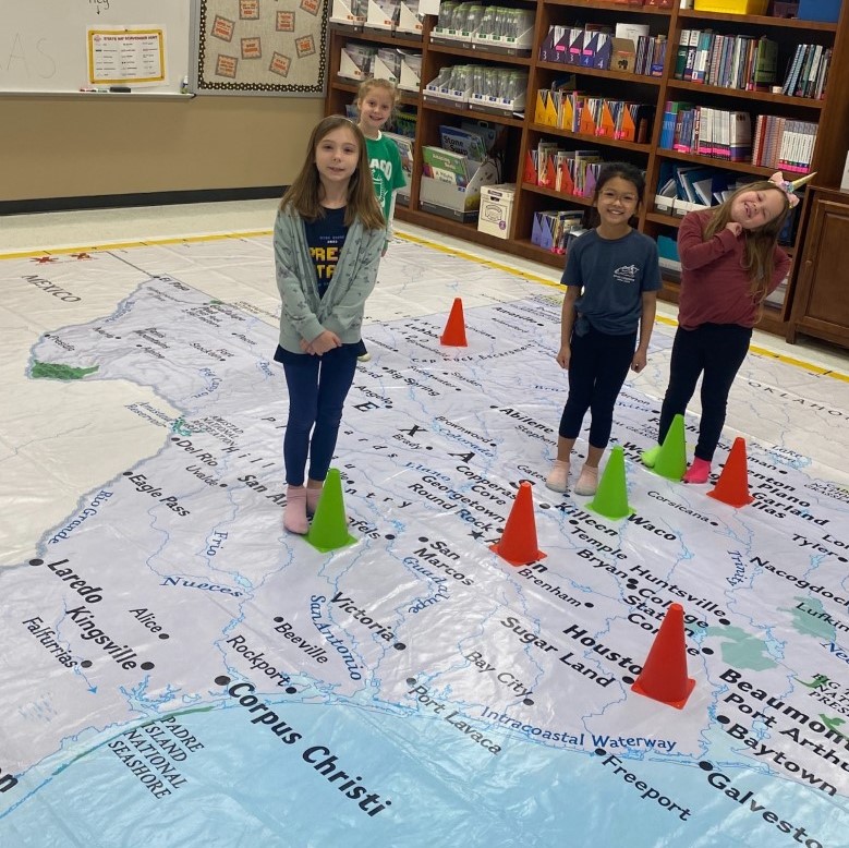 Students at Ride use a GIANT map to learn about Texas!