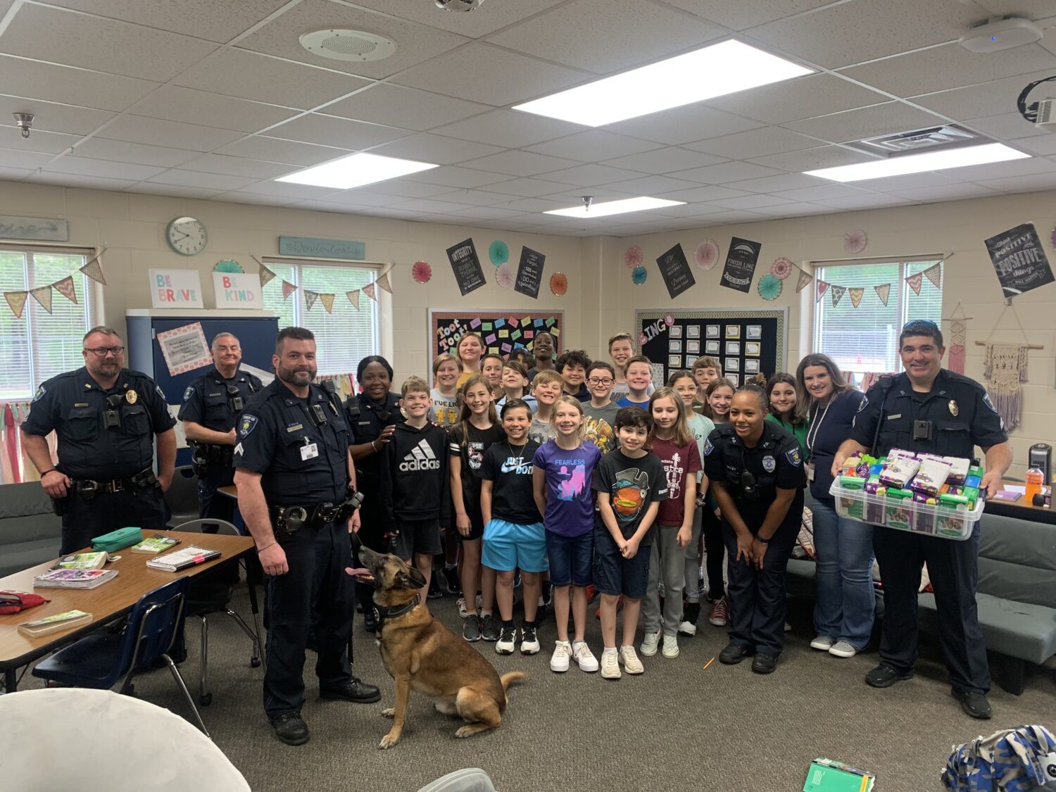 Students at Vogel smile with Conroe ISD Police officers who keep them safe!