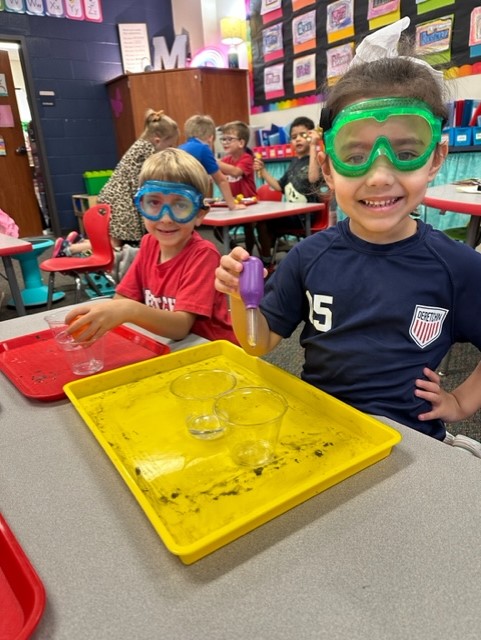 Two boys with googles in science class